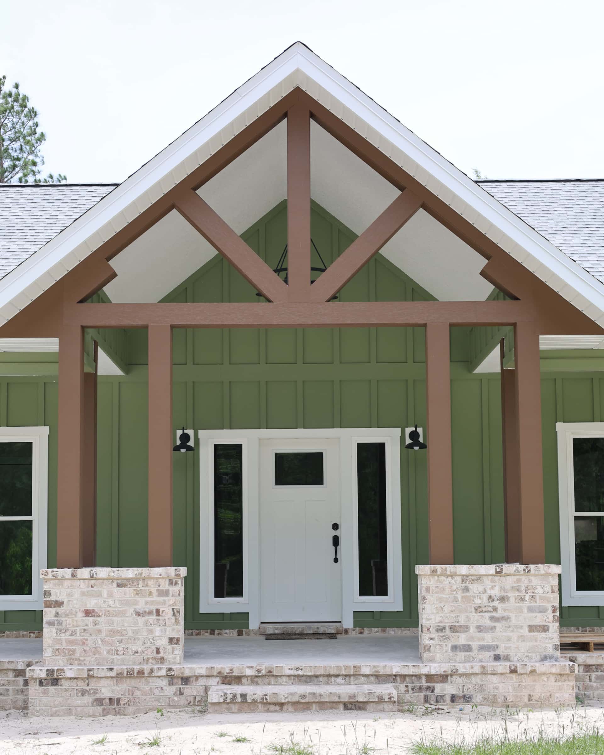 Spacious covered front porch with ceiling fans and seating area